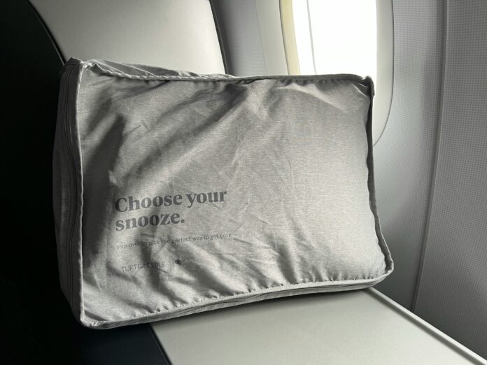 travel pillow next to an airplane window